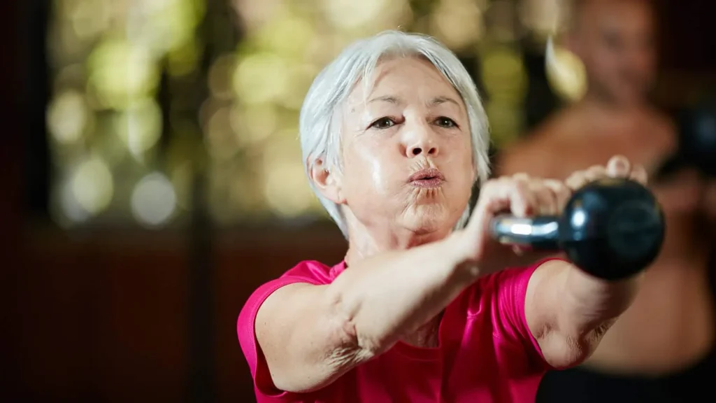 Toning Arms Without the Bulk: Is It Achievable? 1 Woman doing resistance band exercises for toned arms Northwood